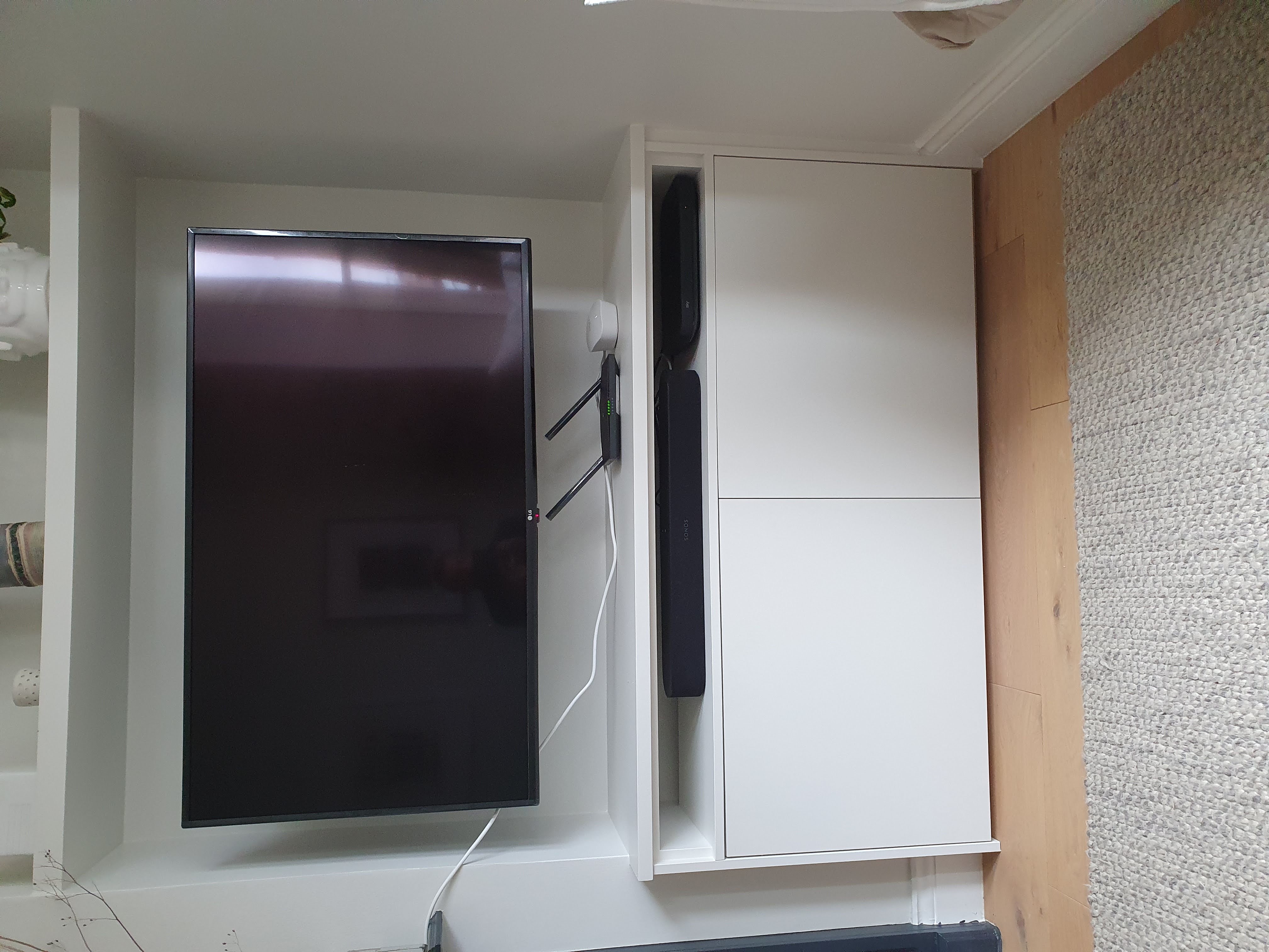 Traditional white alcove units by a fireplace in a living room, featuring open shelving and base cabinets.