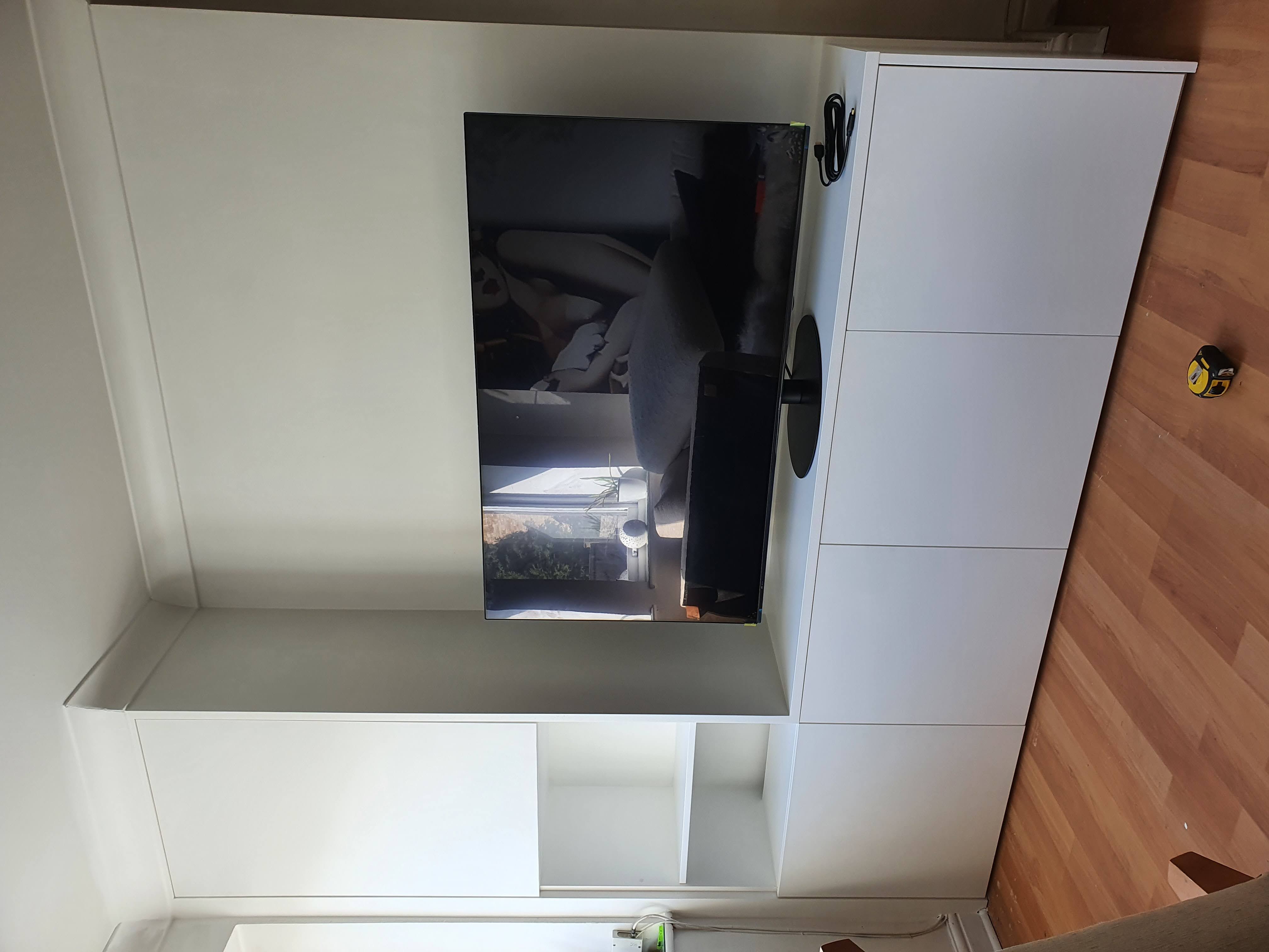 Modern white handleless alcove TV unit in a living room, painted in Dulux Timeless.