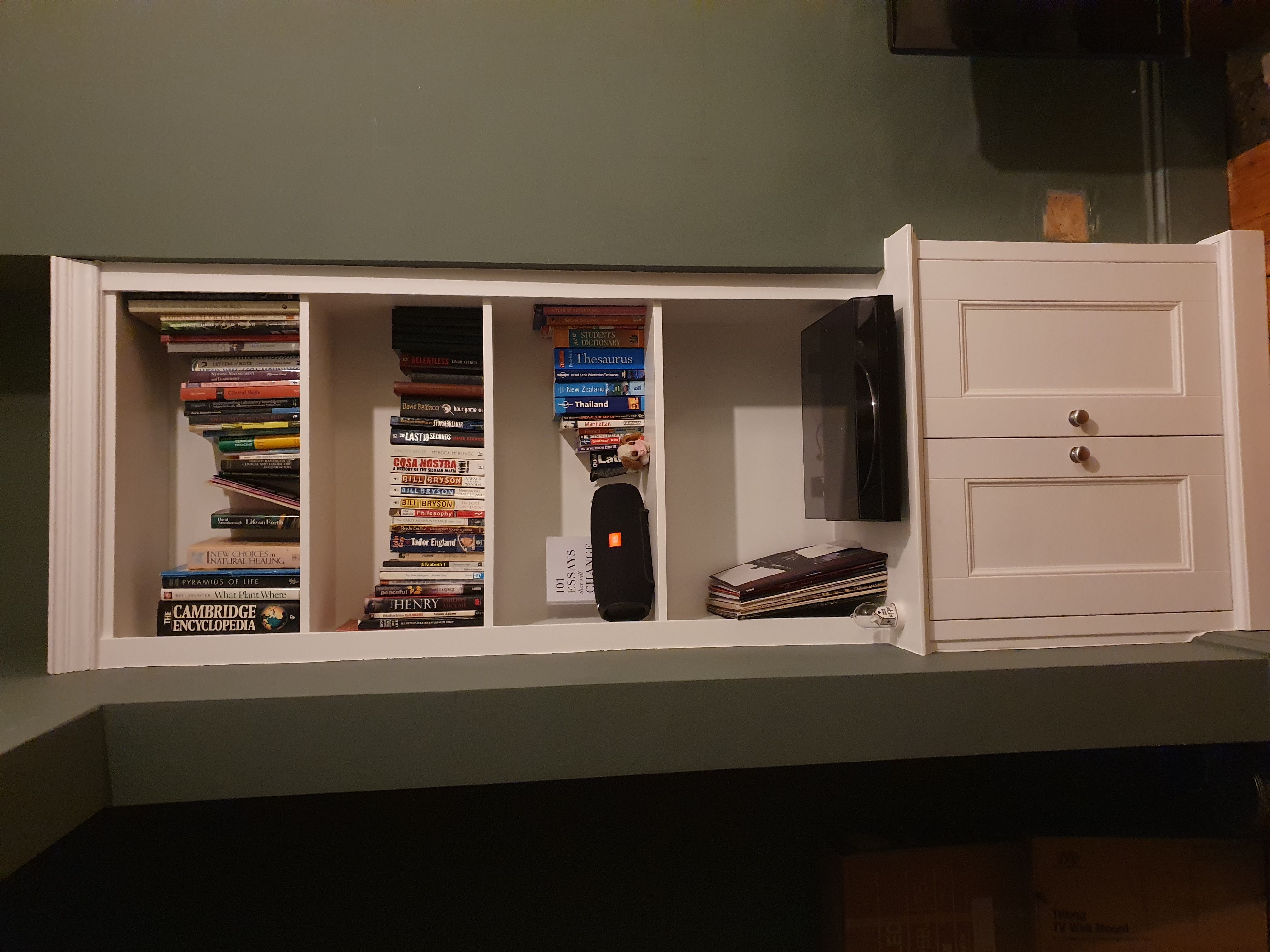 Shaker style white fitted alcove unit with drawers and shelving, perfect for a modern bedroom.