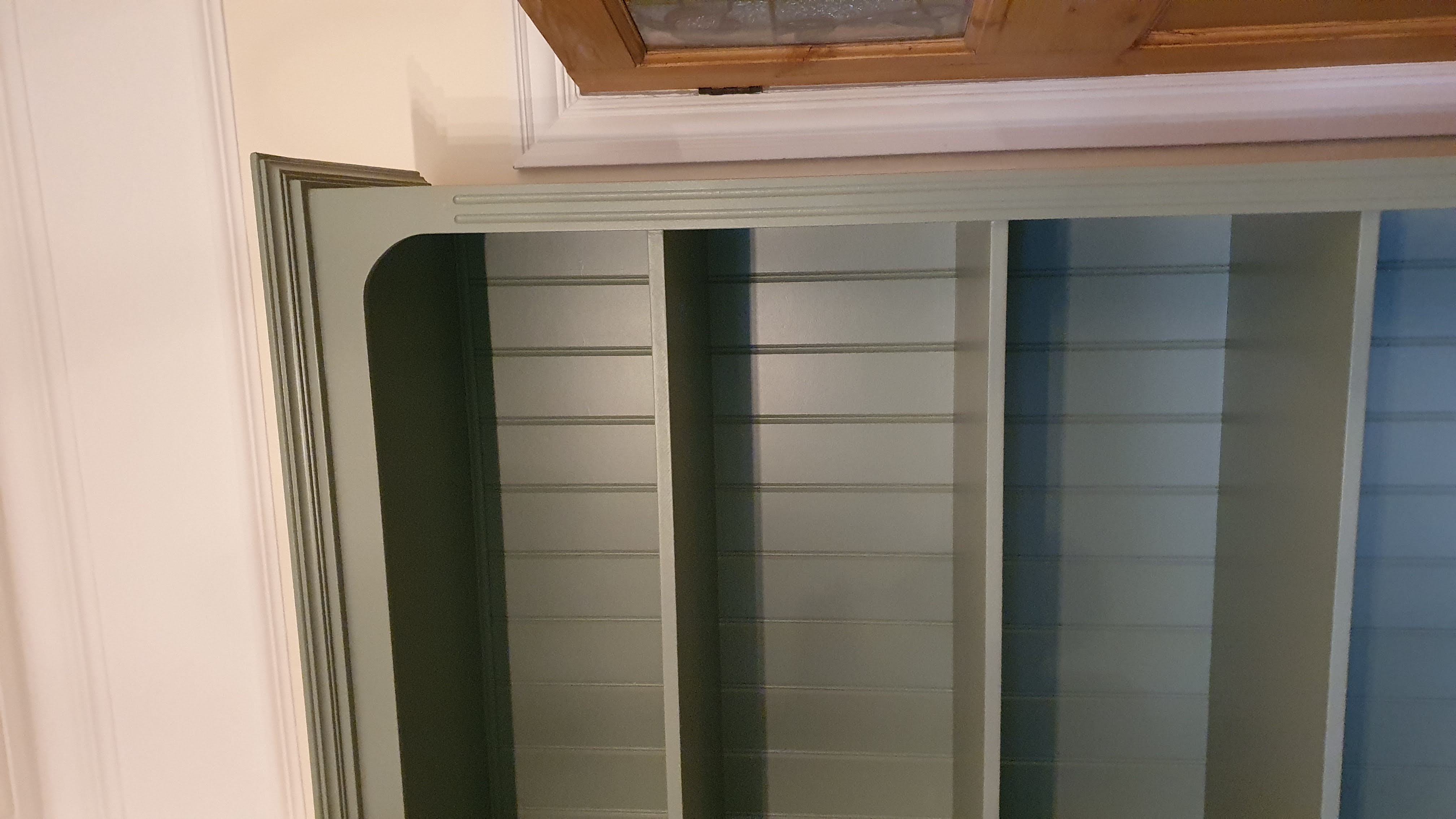 Traditional fitted bookcase in French Gray, featuring open shelving and a base cabinet with Shaker-style doors, ideal for a living room.