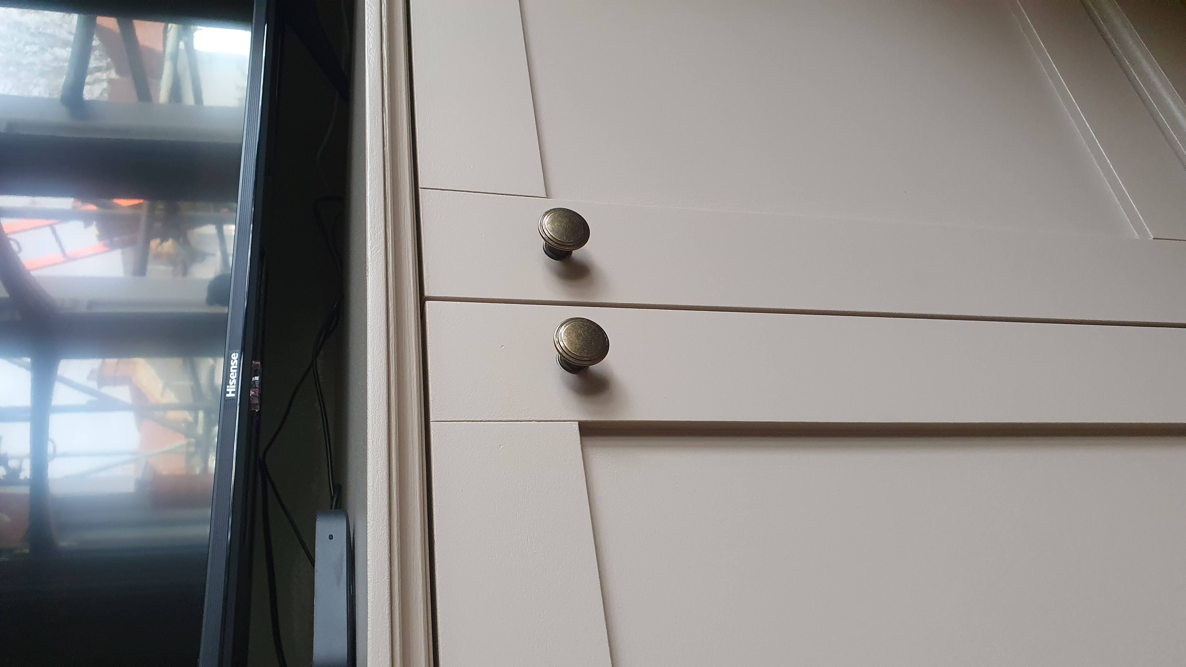 Fitted Shaker style alcove cabinet in Skimming Stone, perfect for living room TV storage.