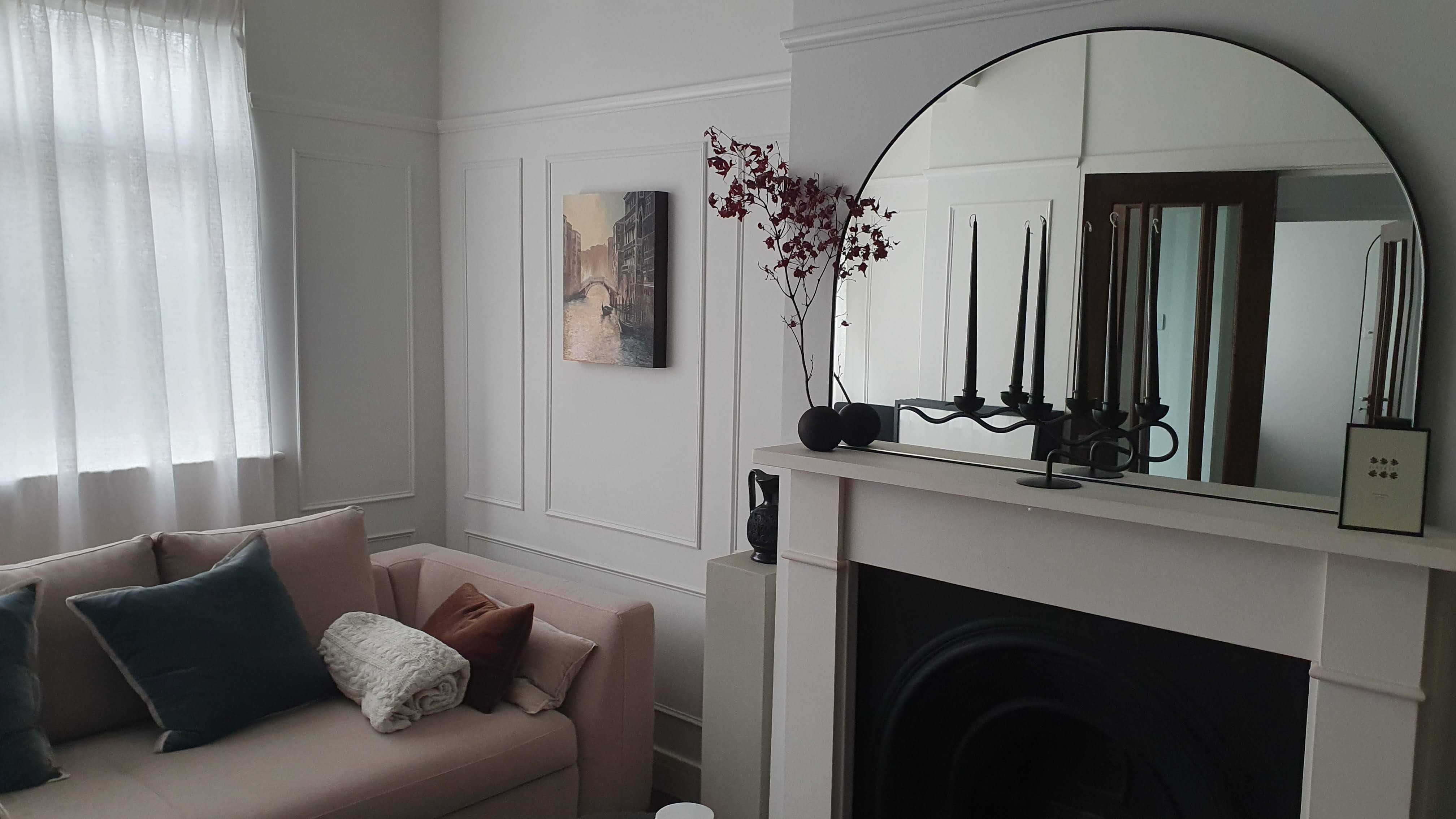 Traditional Wimborne White wall paneling in a living room, adding classic architectural detail.