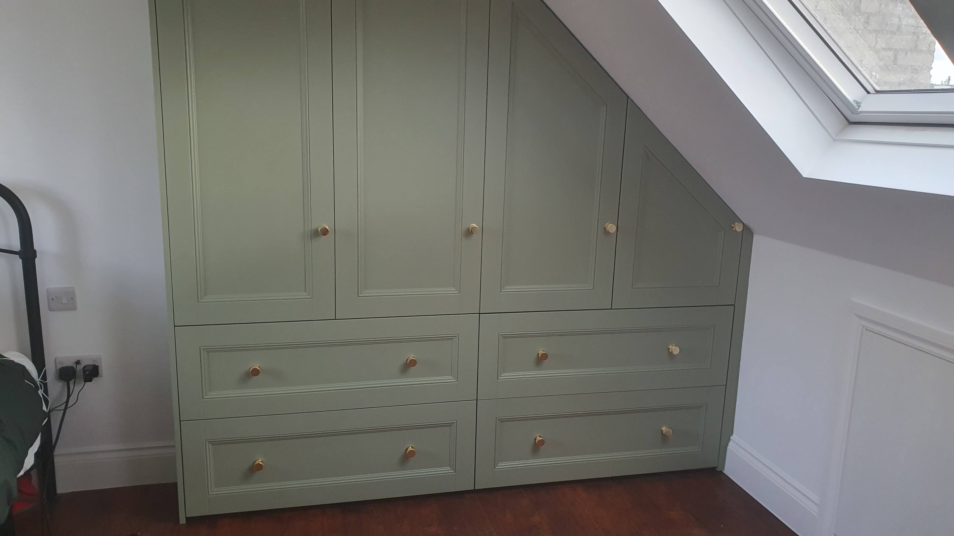 Fitted Shaker style wardrobe in a serene French Grey Mids paint, perfectly integrated into a bedroom with a sloped ceiling.