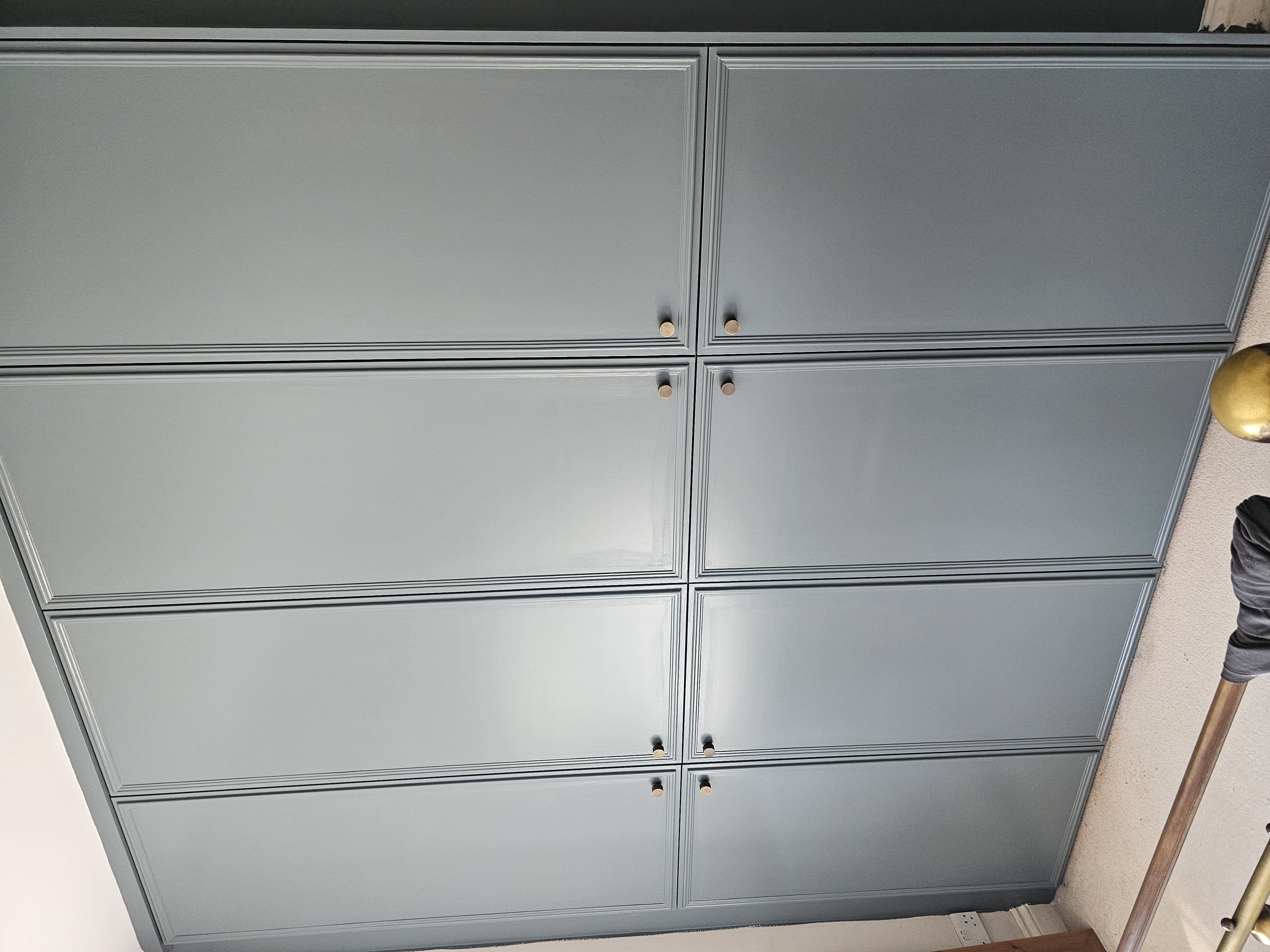 Traditional fitted wardrobe in Hague Blue with brass knobs for a bedroom.
