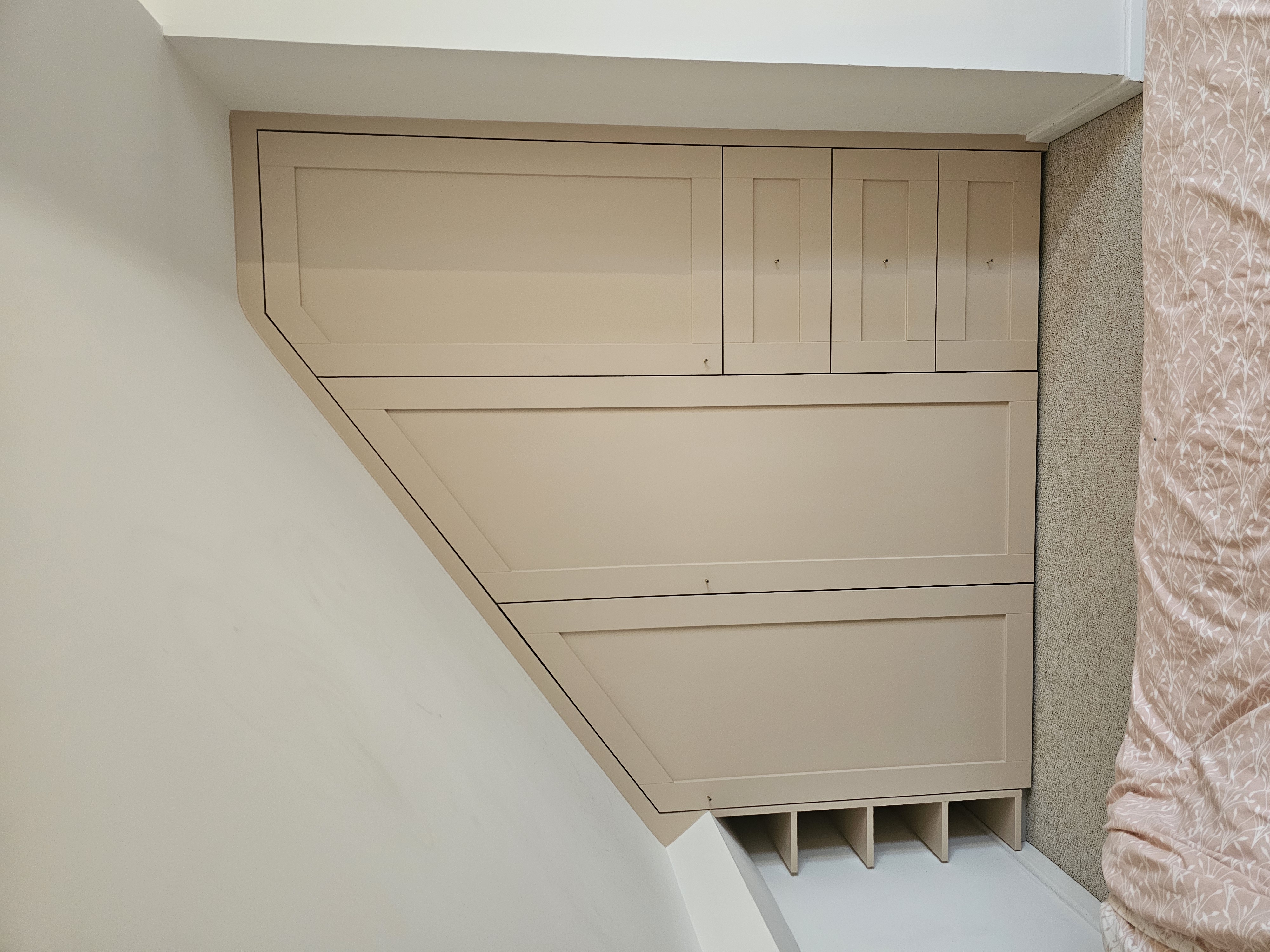 Skimming Stone Shaker fitted wardrobe with drawers and open shelving, designed for a bedroom with a sloping ceiling.