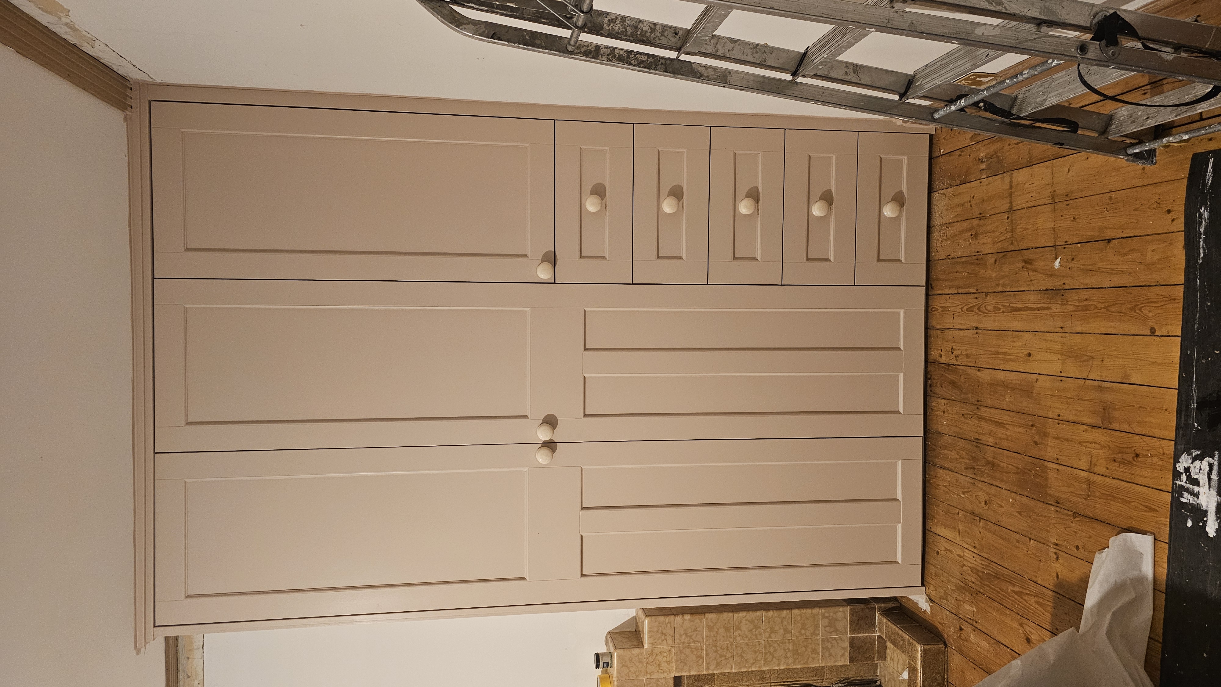 Fitted Shaker style wardrobe in Farrow and Ball Skimming Stone paint, perfect for a modern bedroom.