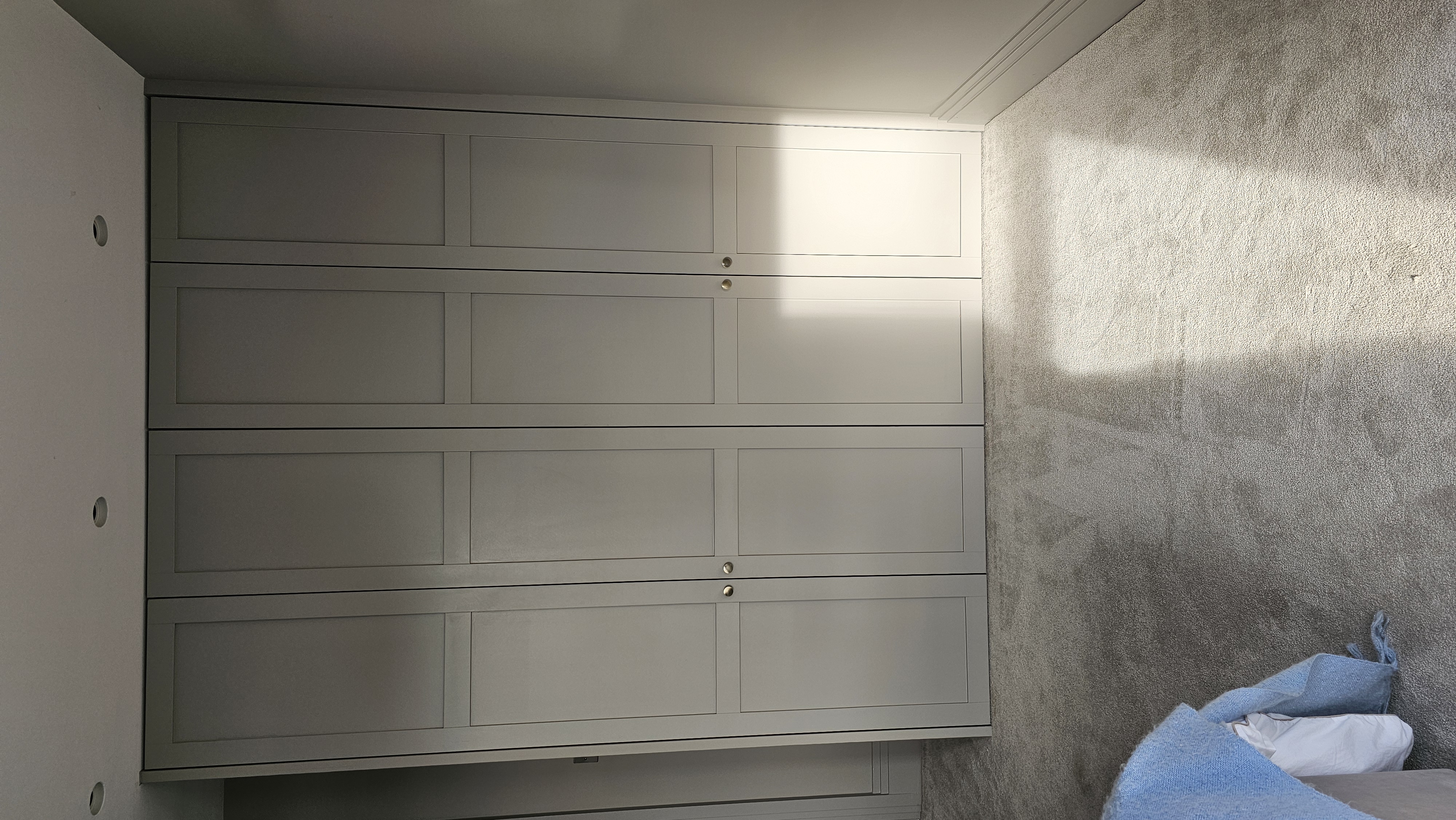 Fitted Shaker style wardrobe in Grey Stone paint finish for a modern bedroom.