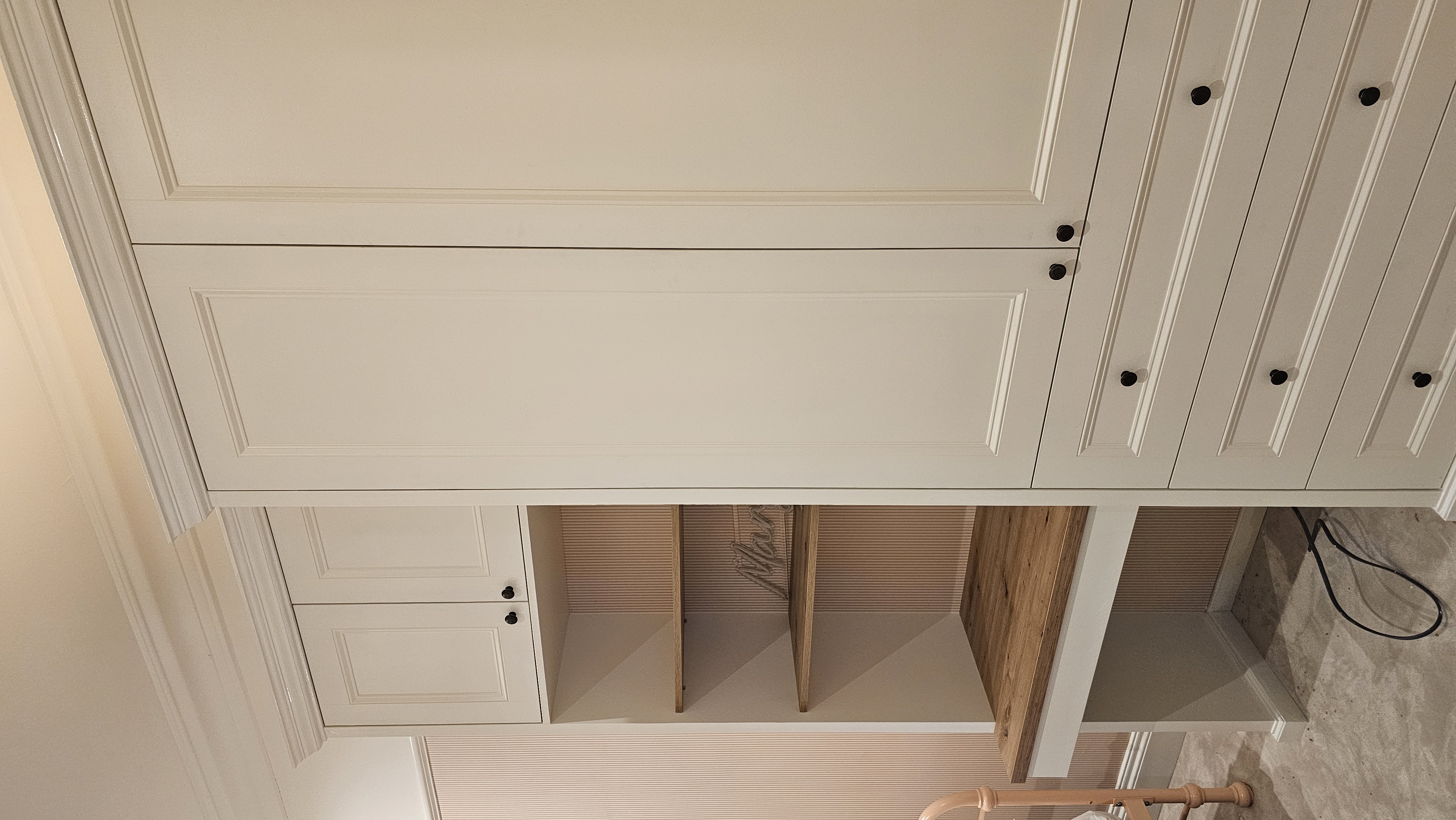 Fitted Shaker style wardrobe with integrated desk unit in a pale neutral 'Shiitake' paint, perfect for a bedroom.
