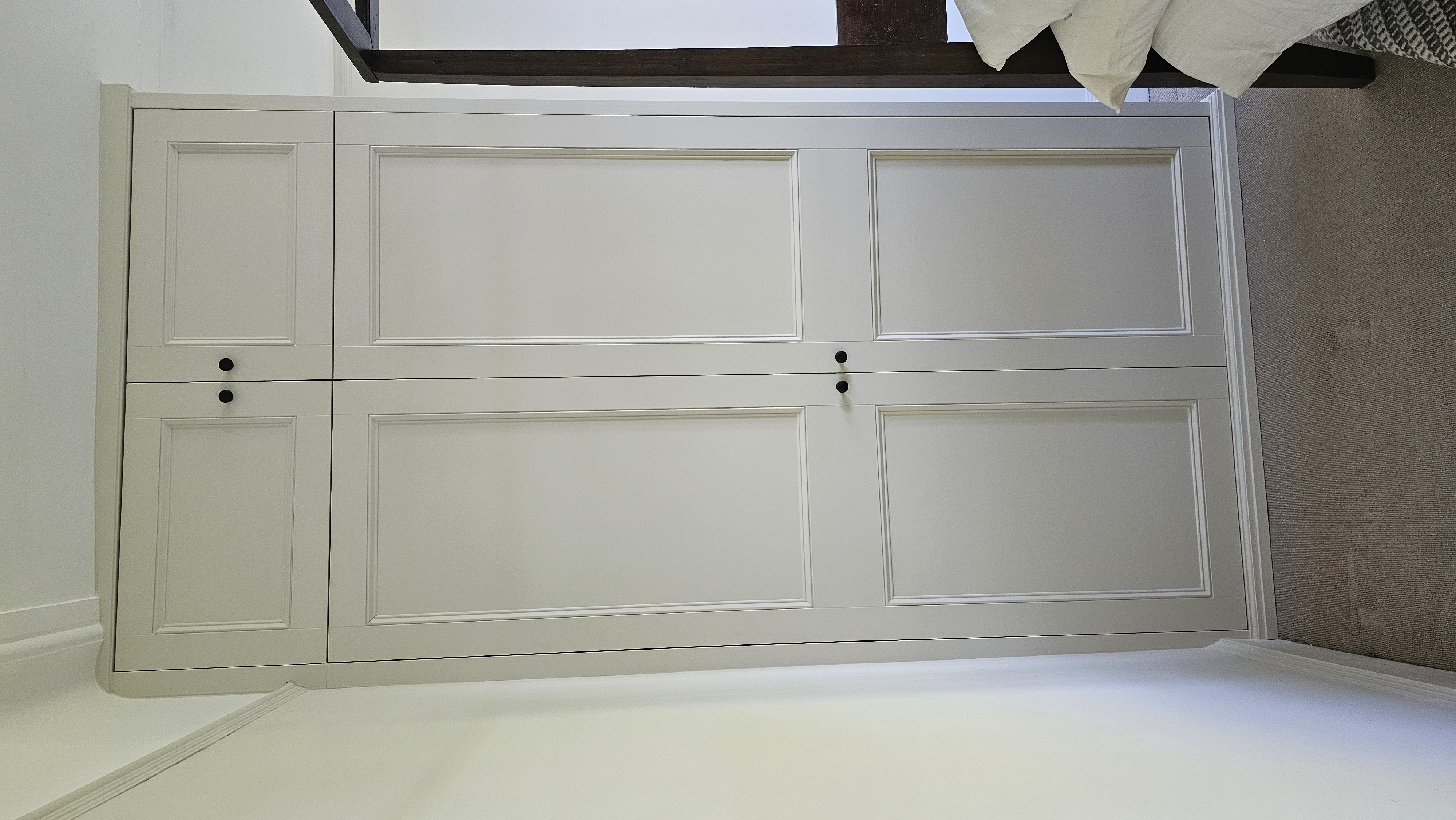 Neutral Shaker style fitted wardrobe in Slaked Lime, perfect for a traditional bedroom.