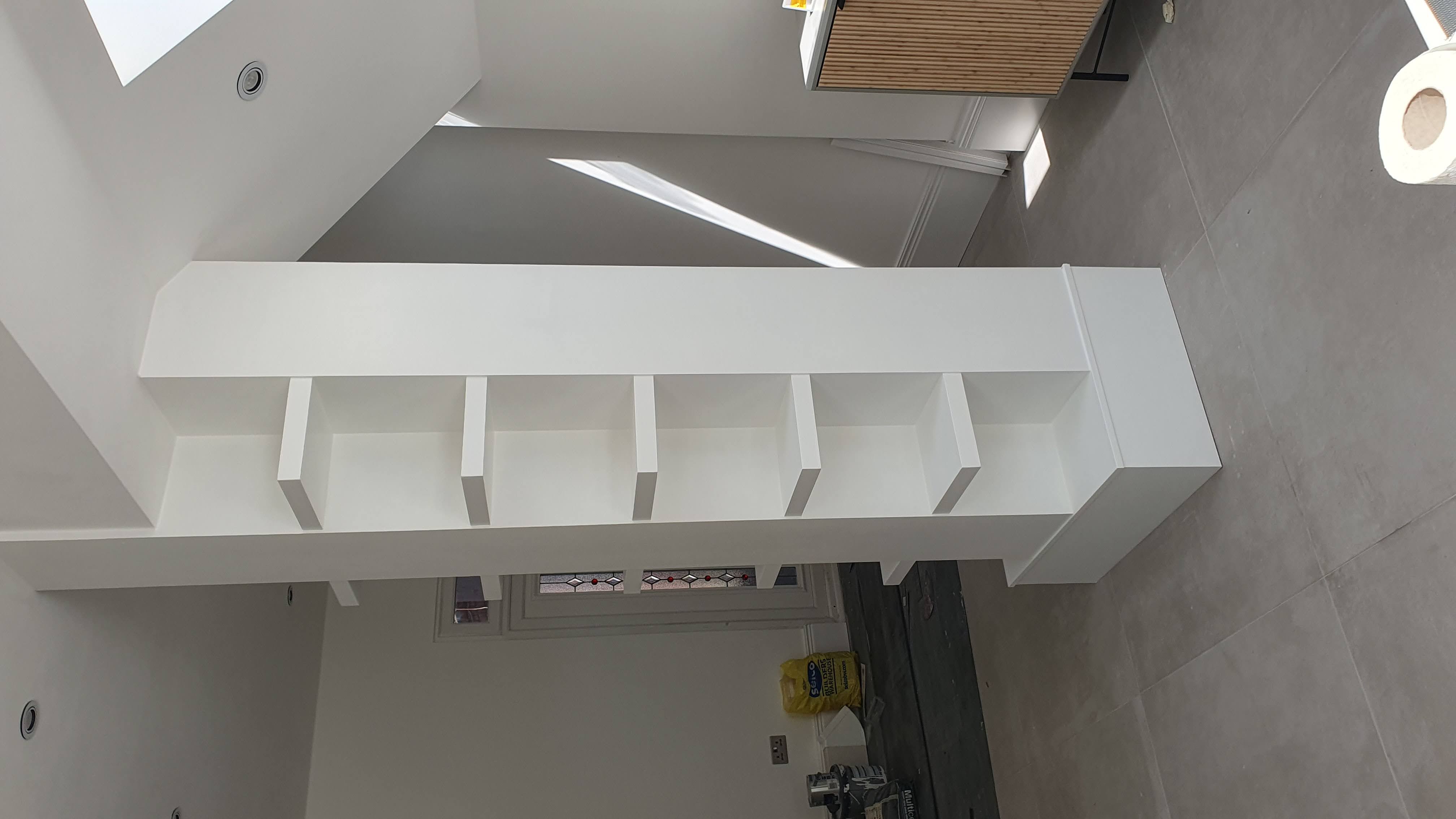 Contemporary built-in shelving unit in Timeless white, integrated into a pillar in a living room.
