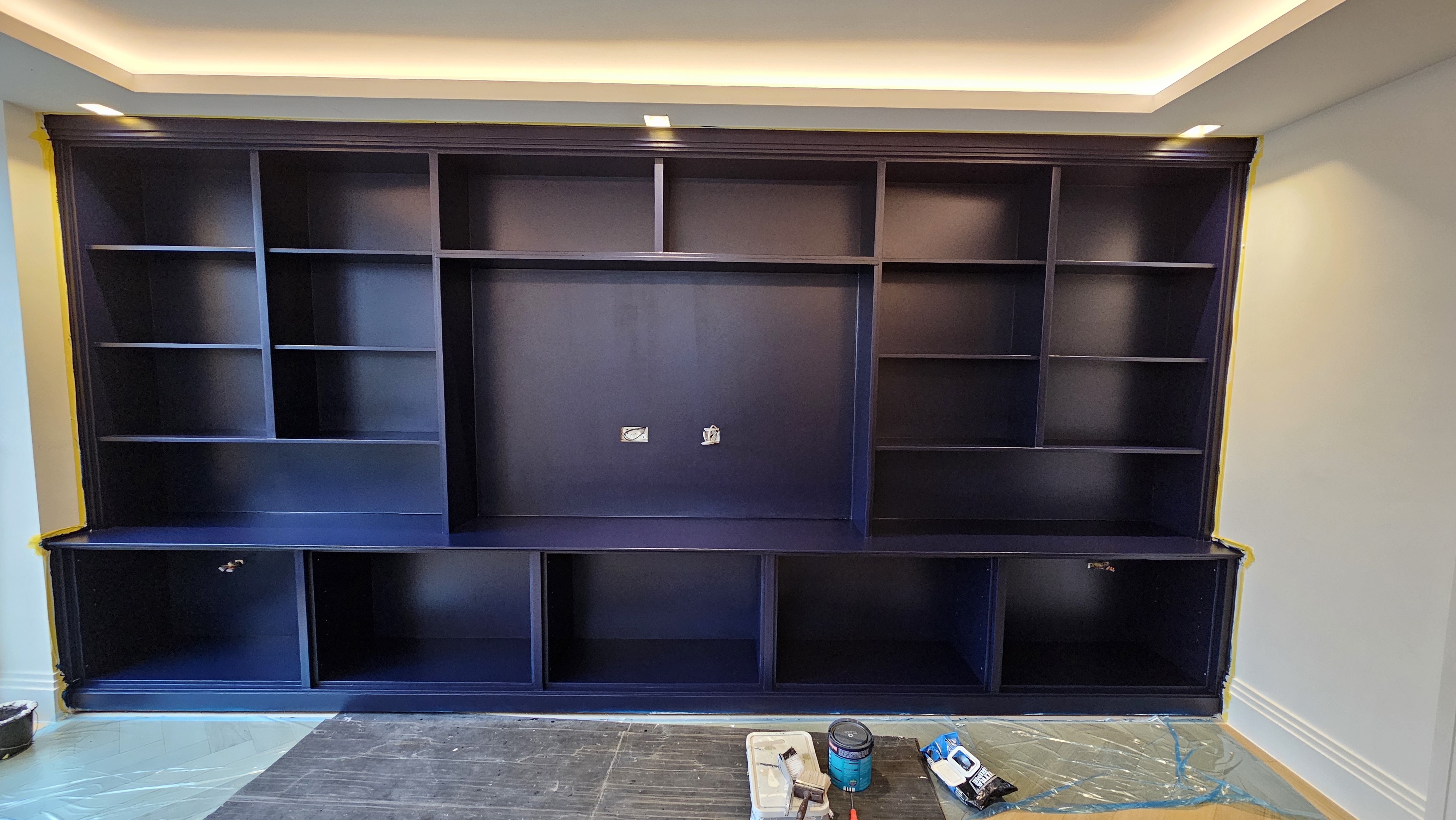 Traditional fitted media unit in deep Hague Blue, featuring shelving and base cabinets, perfect for a living room.
